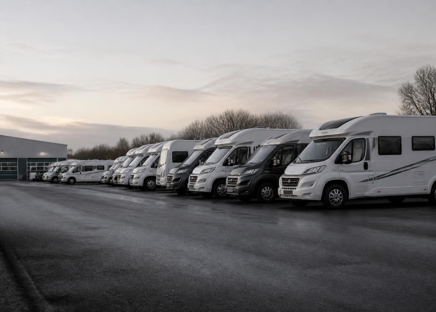 Hire motorhomes lined up on a depot forecourt