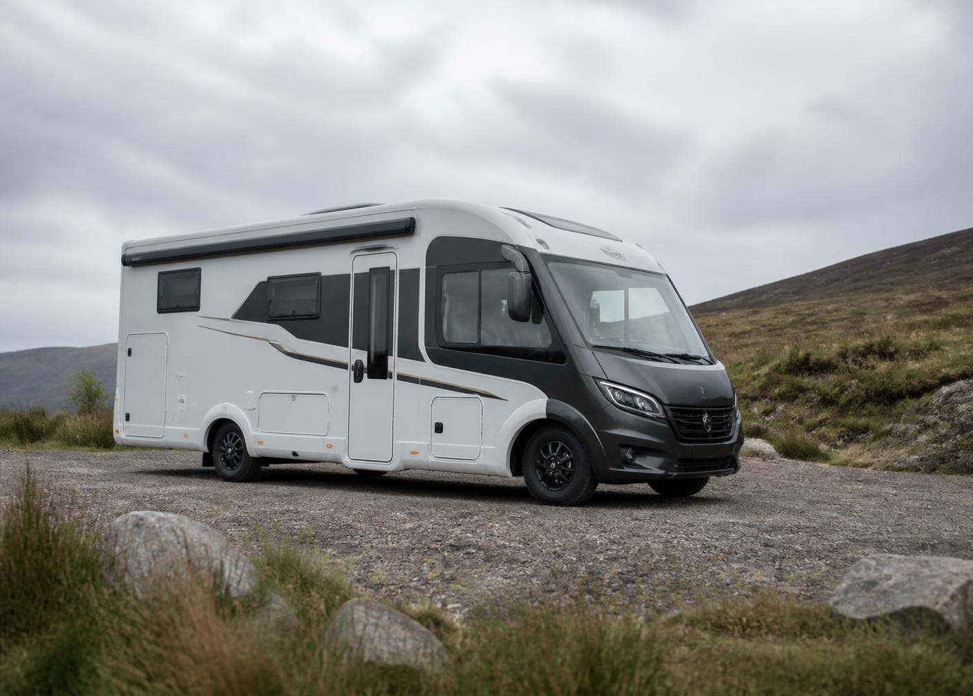 A motorhome parked in a mountain valley